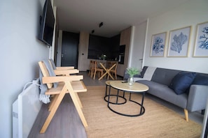 Experience modern comfort in this stylish living area, featuring chic decor and an open kitchen for a perfect getaway.