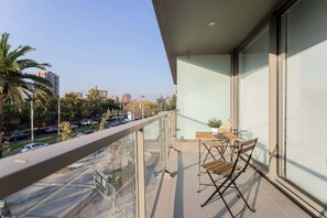 Enjoy a serene balcony with city views, perfect for morning coffee or evening relaxation in this modern retreat.