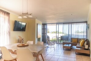 Open plan living/dining room from kitchen. Sliding doors on to private patio.