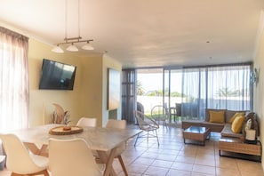 Open plan living/dining room from kitchen. Sliding doors on to private patio.
