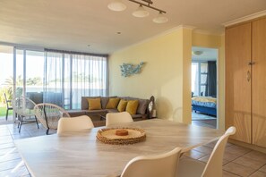 Open plan living/dining room and main bedroom.