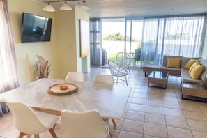 Open plan living/dining room from kitchen. Sliding doors on to private patio.