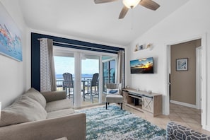 Living room with flat-screen TV and balcony access