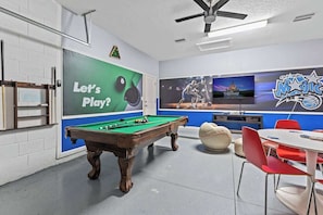 This spacious game room with a pool table, game console, and more is perfect for spending some fun time with your friends during your stay.