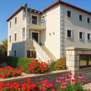 Traditional stone house surrounded by vibrant gardens – a peaceful and charming retreat just minutes from the coast