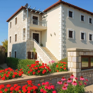 Traditional stone house surrounded by vibrant gardens – a peaceful and charming retreat just minutes from the coast