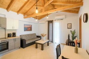 Relax in style with plush seating, a modern kitchen, and ambient lighting under stunning vaulted ceilings