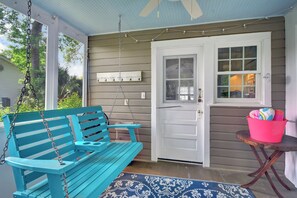 Front Porch Swing at 204 Ashantilly Avenue - Relax on the breezy front porch swing at 204 Ashantilly Avenue, a vacation rental on St. Simons Island just minutes from the beach.