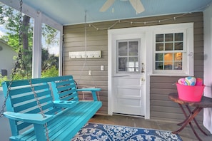 Front Porch Swing at 204 Ashantilly Avenue - Relax on the breezy front porch swing at 204 Ashantilly Avenue, a vacation rental on St. Simons Island just minutes from the beach.