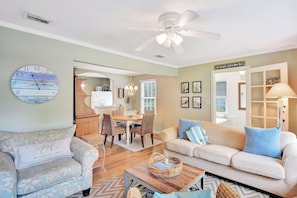 Living Room With Dining View - The main living space at 204 Ashantilly Avenue is light-filled and inviting, with a peek into the dining area for easy-flow vacation living.