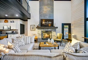 The bright and airy living room invites you to kick back and relax. Cozy up by the fireplace, stream your favorite shows on the smart TV, or just soak in the calming views through the tall windows.