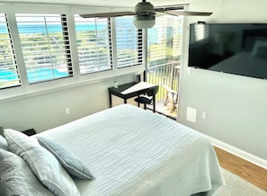 Master bedroom has a tall queen-sized bed, with breathtaking views of the water