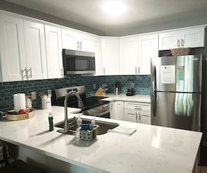 Completely upgraded kitchen, stocked with kitchenware so you can cook in.