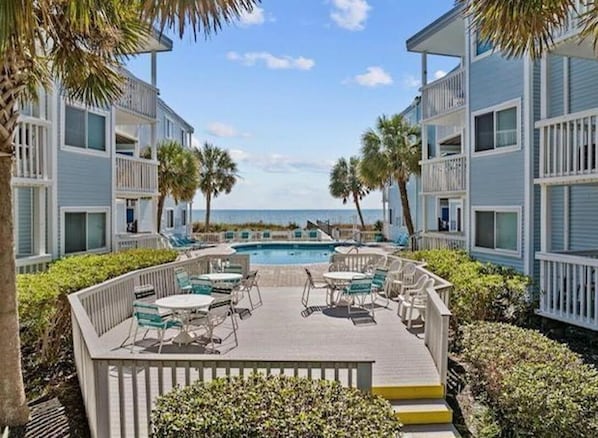 Ocean front condo complex with an inviting outdoor pool.