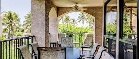 Relax on this covered balcony with tropical views, ideal for dining al fresco or enjoying a serene morning.
