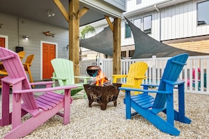 Gather around vibrant chairs and a fire pit for unforgettable evenings!