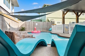 Relax by the sparkling pool on vibrant loungers—your tropical escape awaits!