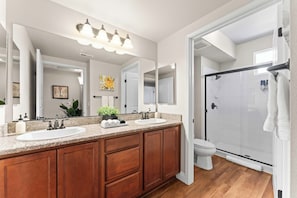 Clean, spacious bathroom with dual sinks, full size shower and all the essentials for a comfortable stay.