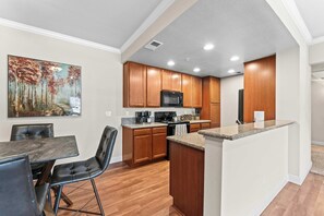 Fully stocked kitchen with dining space—ideal for cooking, working, or gathering over a meal.