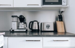 The apartment's kitchen is well-equipped and includes an oven, full-size fridge-freezer, stove, and dishwasher.