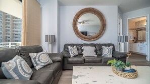 Twin leather sofas command in the living room, with weathered wood accents in the furnishings.