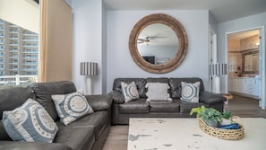 Twin leather sofas command in the living room, with weathered wood accents in the furnishings.
