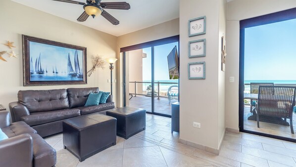 Living room with leather furniture and TV.