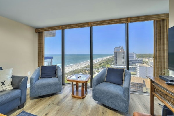 Let in the sun rays as you relax in the comfort of this living room with a view.