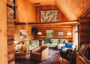 This cozy lodge living room has plenty of seats and activities for all, whether you’re playing chess by the fire or enjoying a heartfelt conversation.