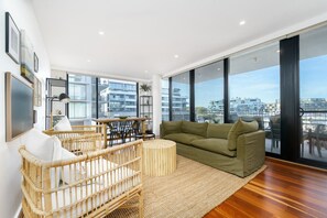 Relax in the lounge and dining area with floor-to-ceiling windows framing a stunning panoramic view of the lake at Trevillian Quay.