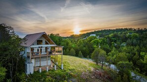 Watch the Smokies glow as the sun sets over Tennessee Whiskey Cabin