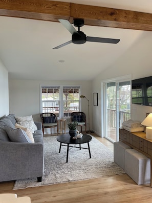 Living room with views of the water and walkout to large covered deck