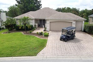 Front of house with 4 person golf cart