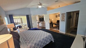 Spacious primary bedroom with office and desk. 