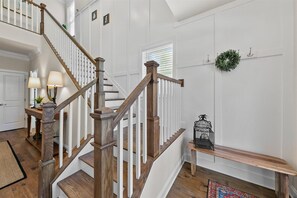 Two-story foyer with turned staircase,