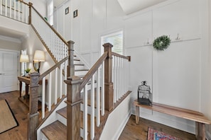 Two-story foyer with turned staircase,