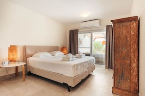 Bedroom 1 features a comfortable king bed, air conditioning, and ample clothing storage for a restful and organized retreat.
