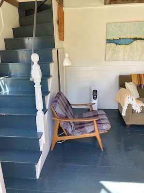Antique steep stairs next to living room