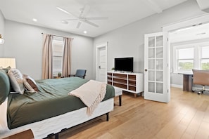 Second floor primary bedroom with king bed and sun room