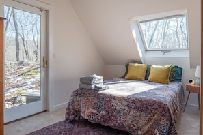 The queen bed in the loft bedroom.
