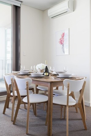  Come together at the spacious dining table, set for six.