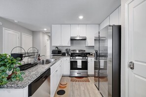 Fully equipped kitchen with high quality granite countertops. 