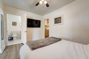 Cozy bedroom with a plush bed, ceiling fan, and smart TV for ultimate comfort.