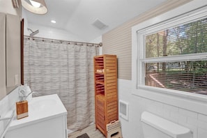 Step into a spa-like sanctuary—where soft lighting and a walk-in shower set the stage for intimate, end-of-day unwinding.