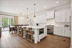 Cook like a pro or entertain with ease in this Chef's kitchen designed for culinary creativity with a big kitchen island that has a double dishwasher.