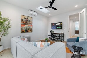 Relaxation meets productivity—this family room has it all, from streaming vibes to a workspace that even the boss would envy.