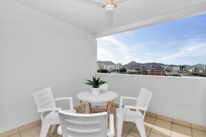 Dine alfresco on your private balcony, taking in gorgeous views across the mountains and city.
