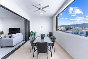 Dine alfresco on the spacious, semi-enclosed balcony, where a six-seater setting overlooks the city and stunning mountain vistas.   
