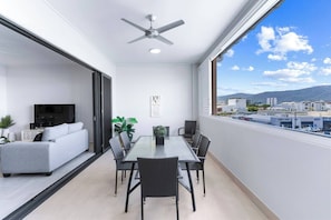 Dine alfresco on the spacious, semi-enclosed balcony, where a six-seater setting overlooks the city and stunning mountain vistas.