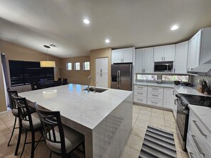 Large kitchen island with 6 person dining table